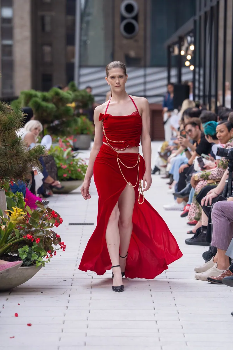 Scarlet velvet gown with pearl chains on the New York Fashion Week runway